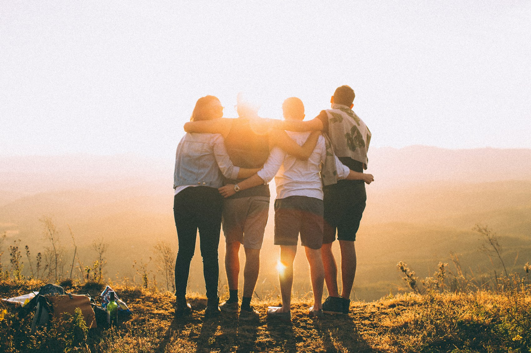 A group sharing a joyful hug outdoors