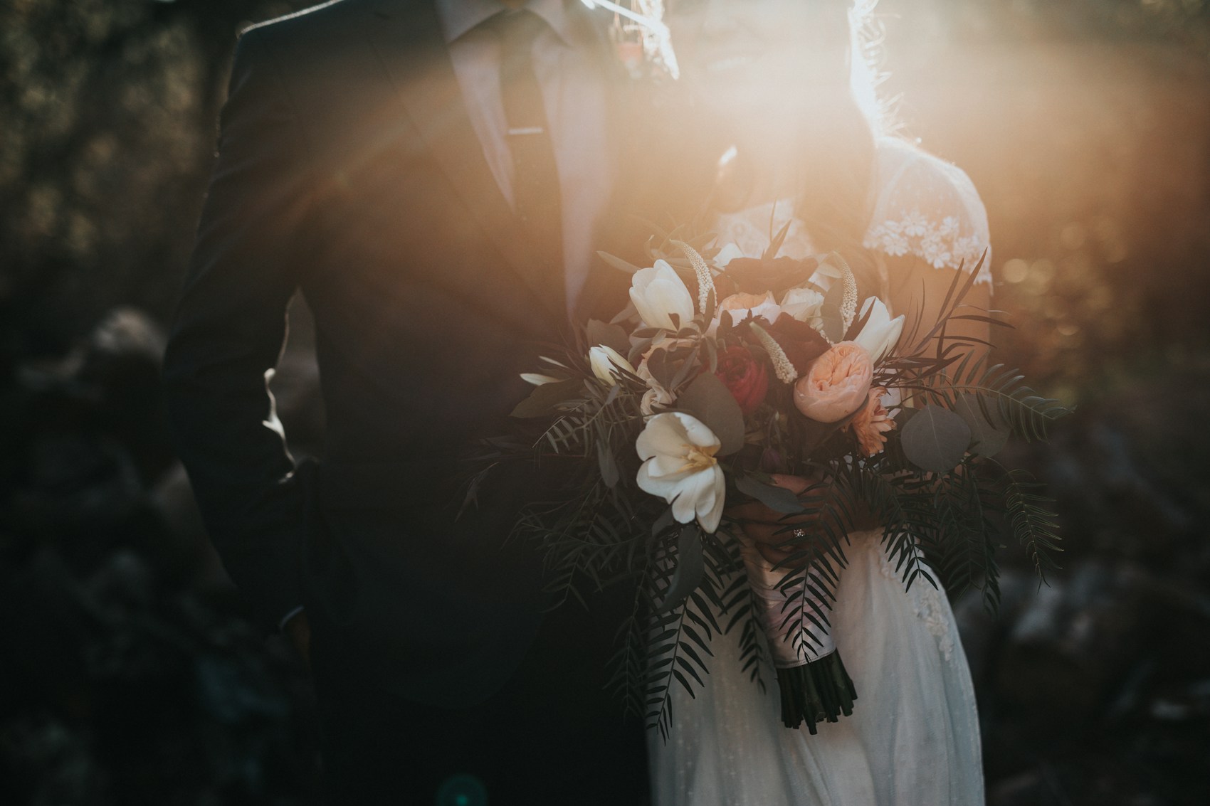 Wedding flowers and a couple in soft evening light