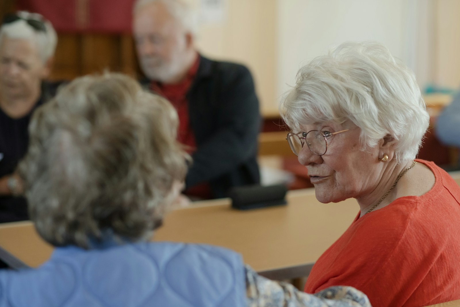 Illustrative older adults enjoying a conversation